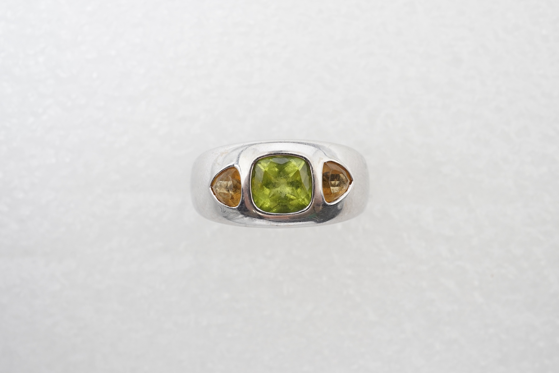 A peridot and citrine dress ring